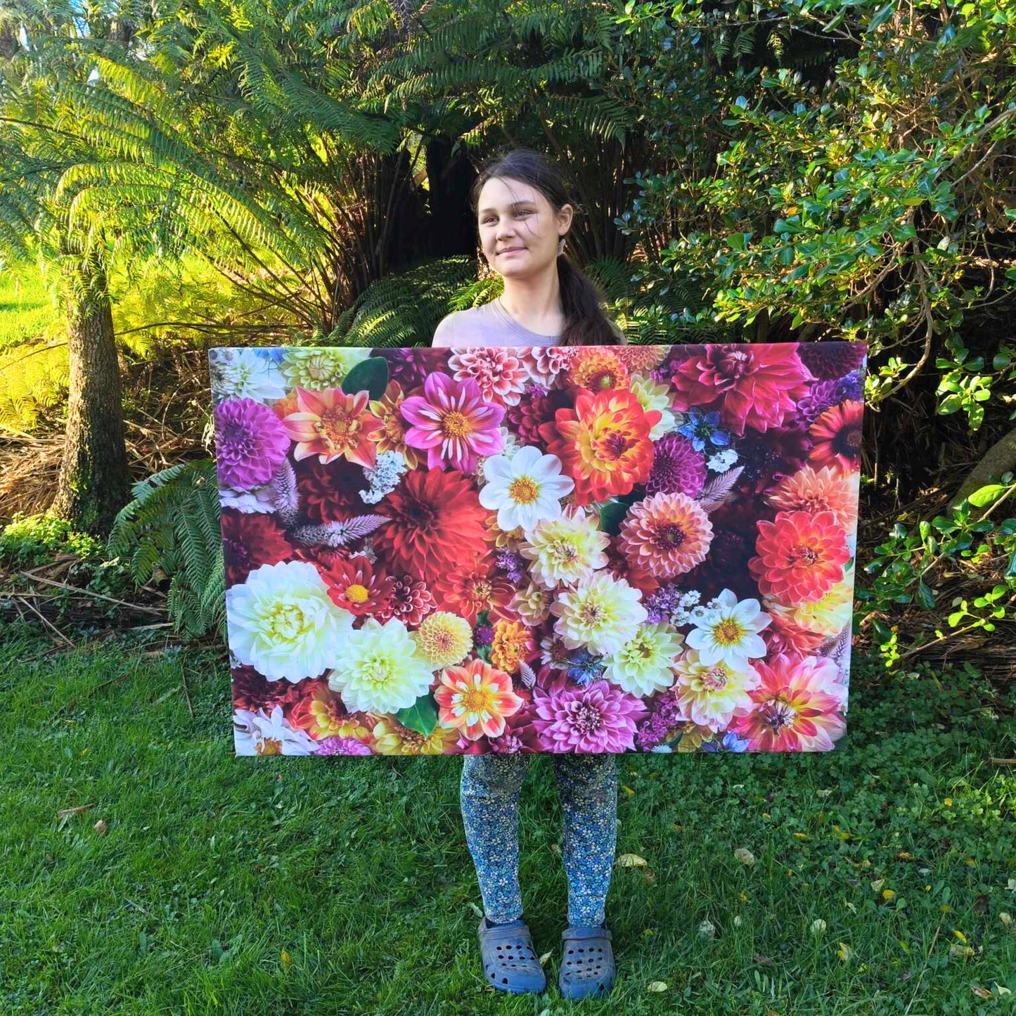 Gracie-Mae holding her large canvas 120 cm x 80 cm called Stunning Dahlia Delights.