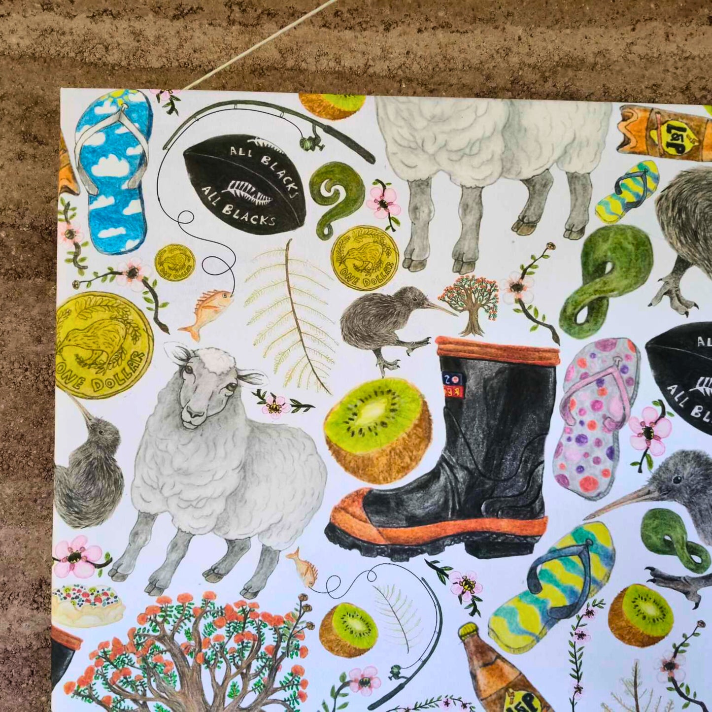 A close up of a kiwiana canvas showing sheep, gumboot and kiwi bird.