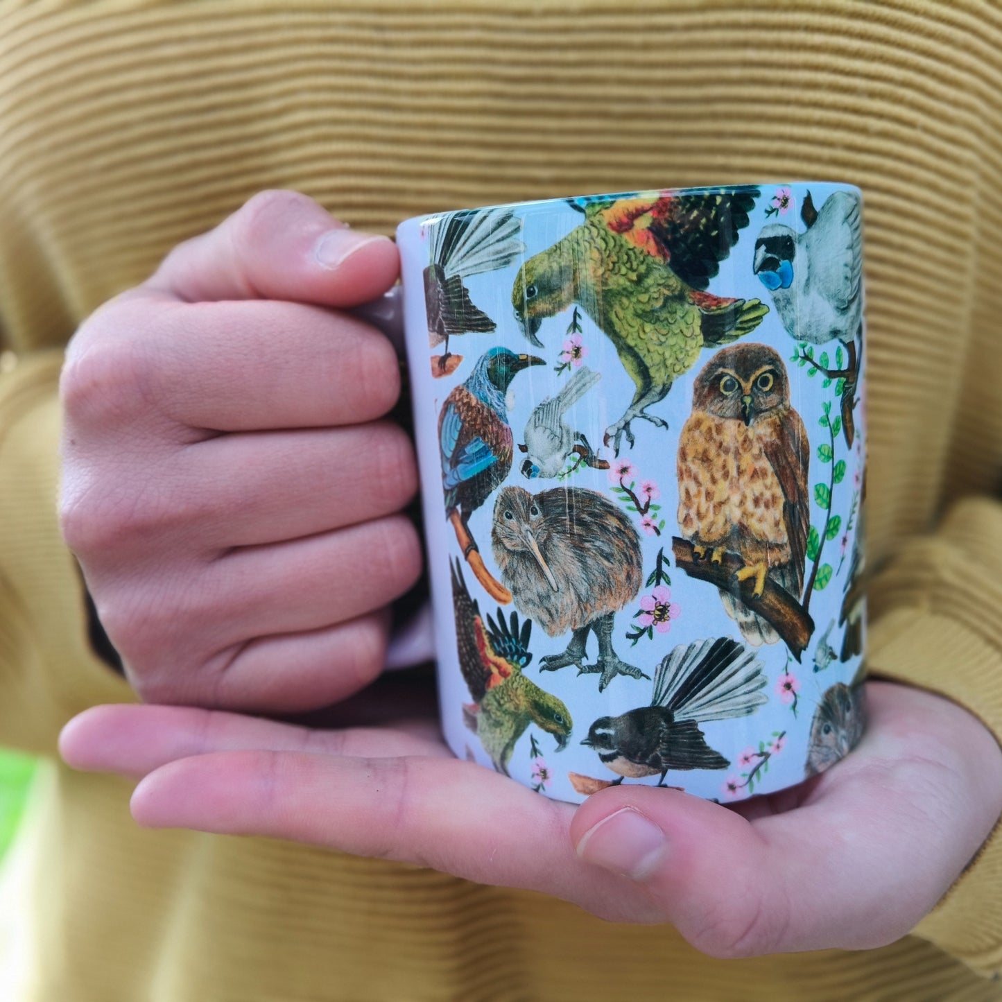 Milly’s hand-drawn NZ Birds design on ceramic mug from The Stripey Caterpillar