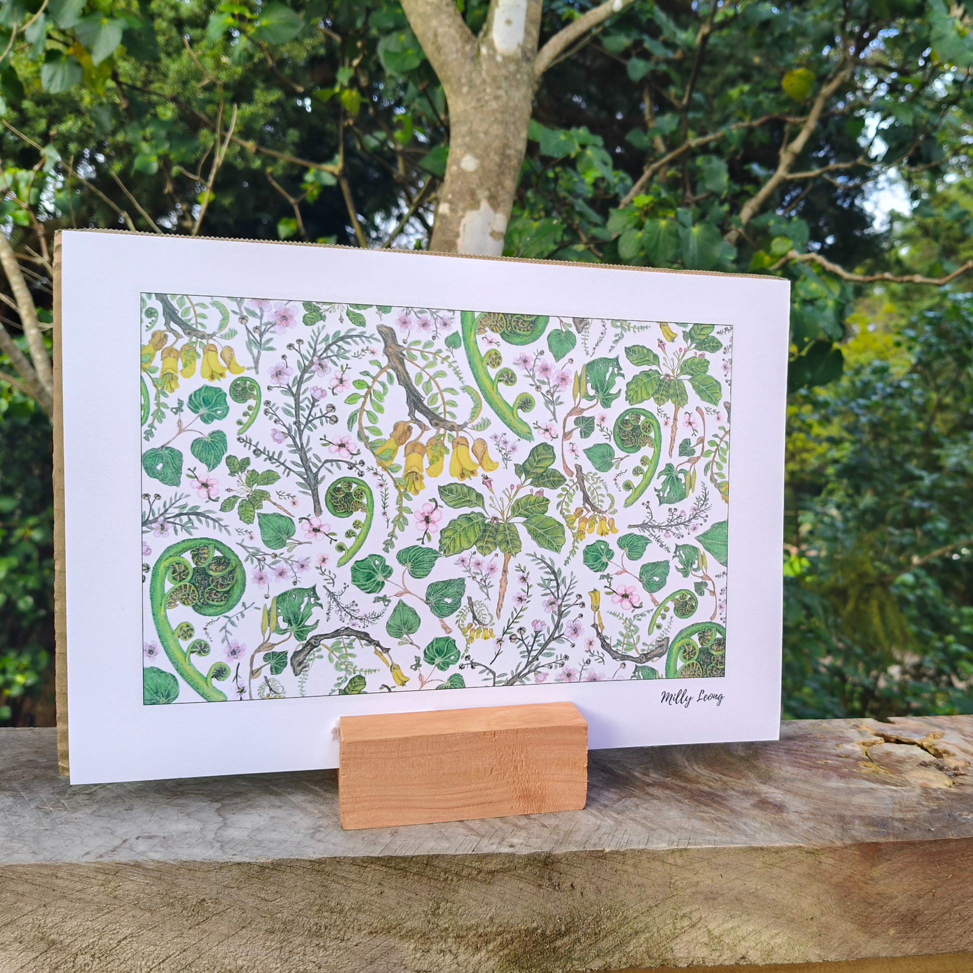 Decorative print with nature-themed design on a stand against a natural background