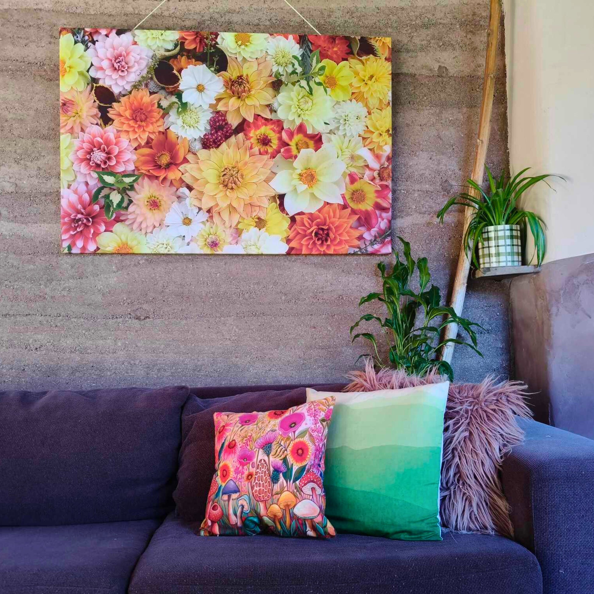 A large colourful canvas with a flatlay full of orange themed dahlias bred and photographed by Gracie-Mae Photography.