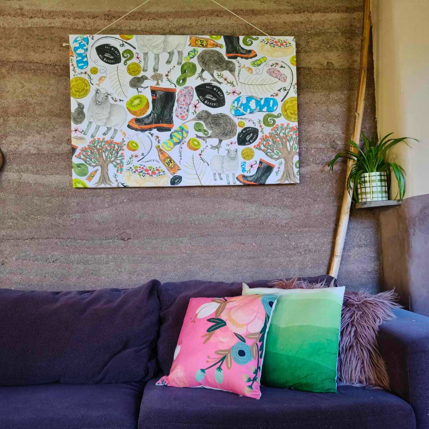 A 120cm x 80cm canvas hanging behind a brown sofa full of New Zealand native birds hand-drawn by Milly from The Stripey Caterpillar.