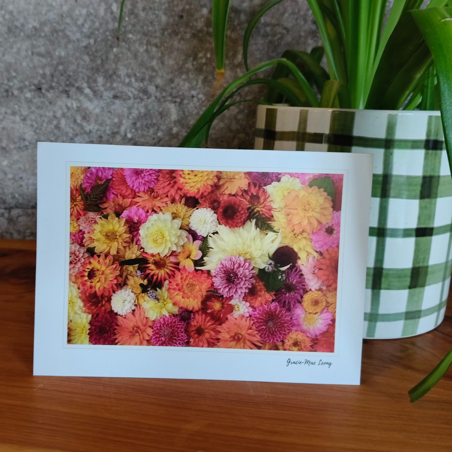 Greeting card featuring bright orange dahlia flatlay by Gracie-Mae – blank inside