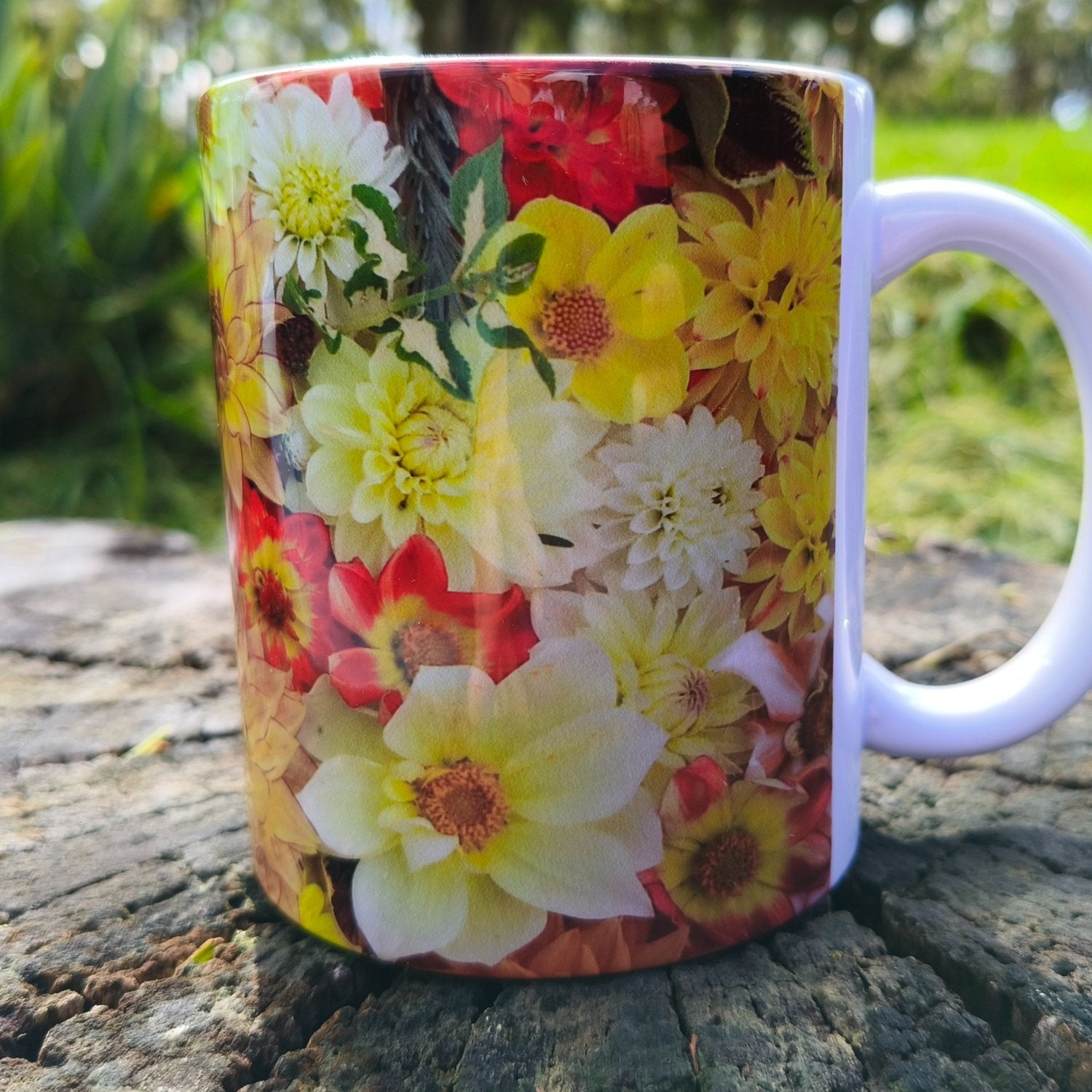 A bright cheeful mug with sunny dahlias wrapping all around it bred and photographed by Gracie-Mae Photography.